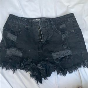 Women’s black ripped jean shorts.